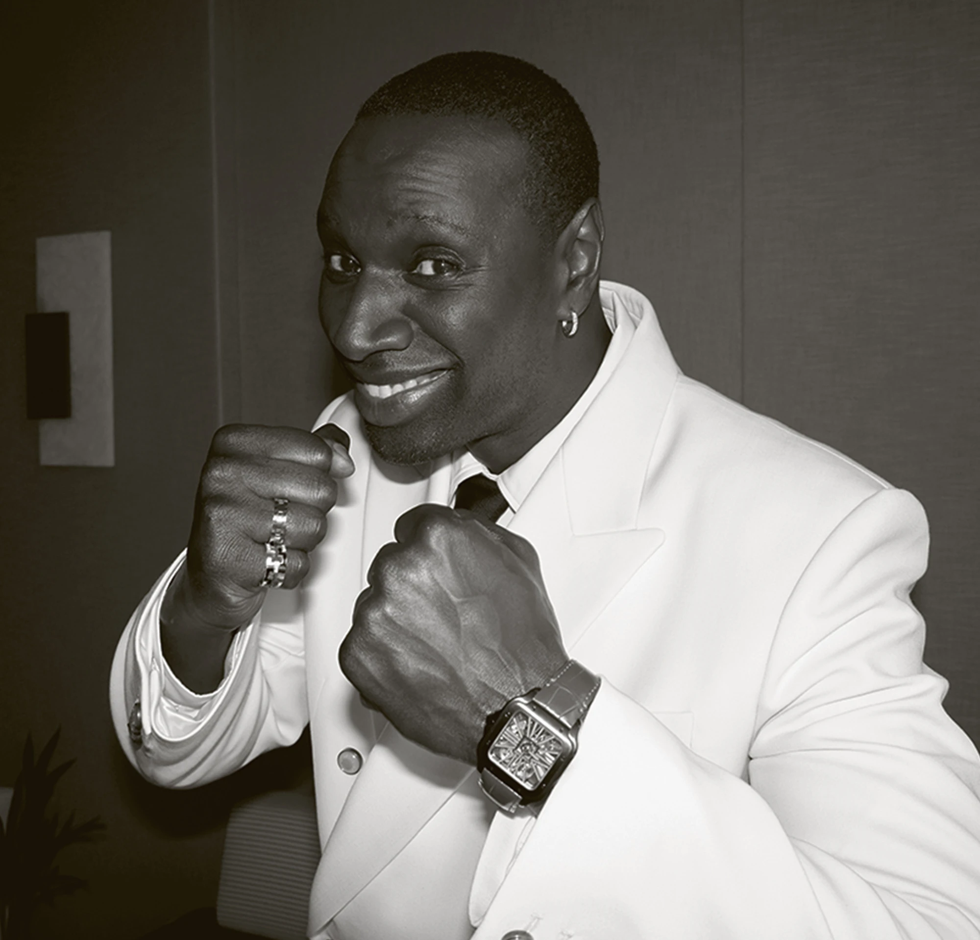 Black and white photo of a black male on a white suit