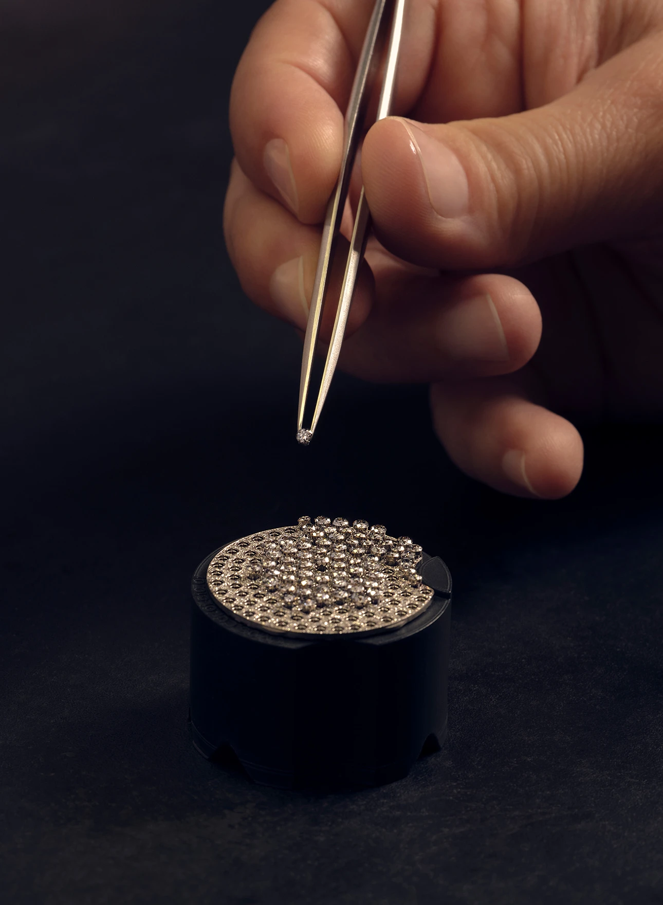 Photo of a hand crafting a jewel