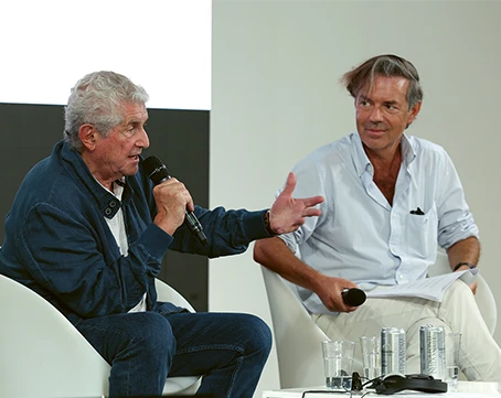 Photo of Claude Lelouch and Stéphane Lerouge speaking at an interview